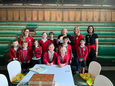 Jane with the students with an image of the house of commons chamber in the background